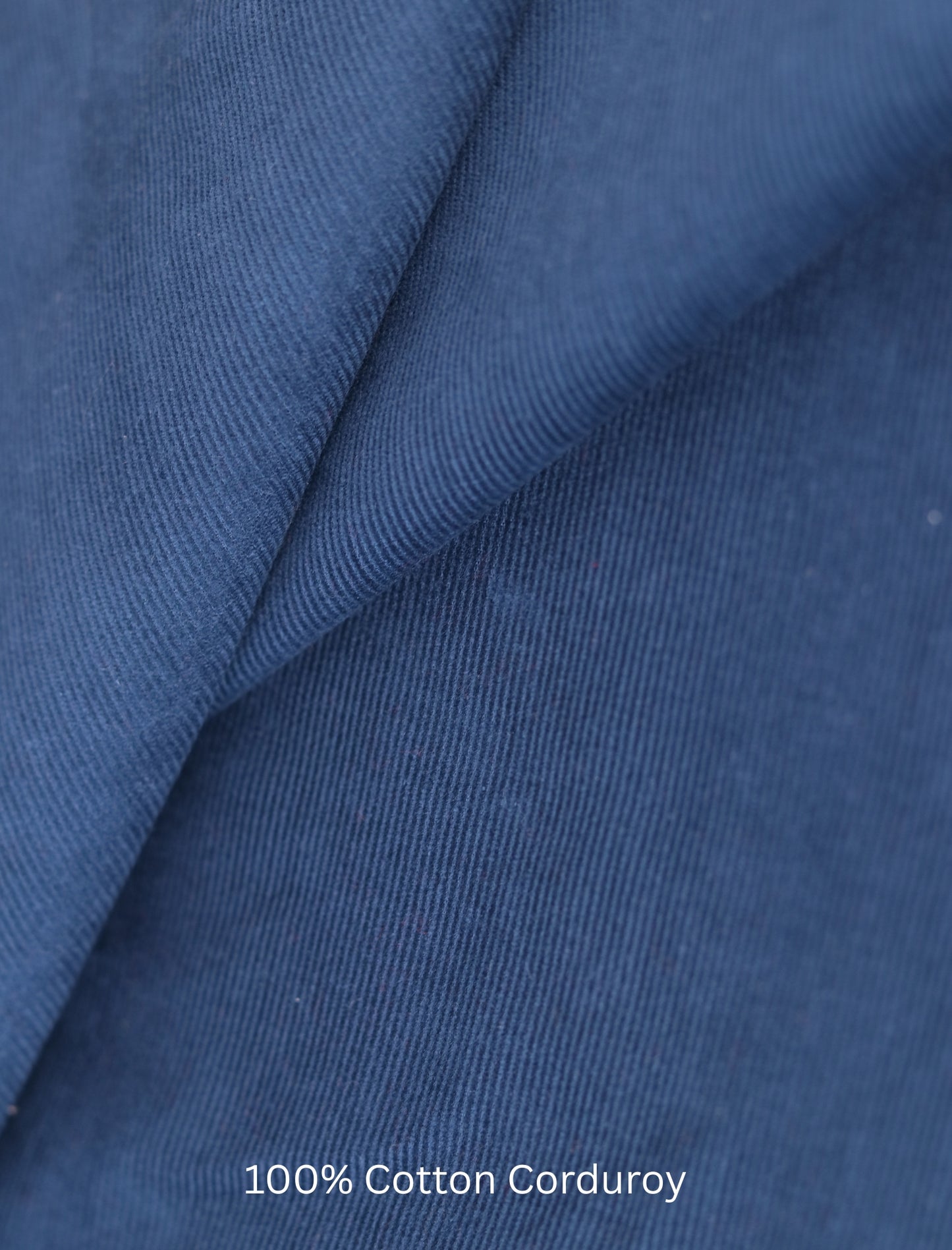 Close-up of blue 100% cotton corduroy fabric with text overlay.