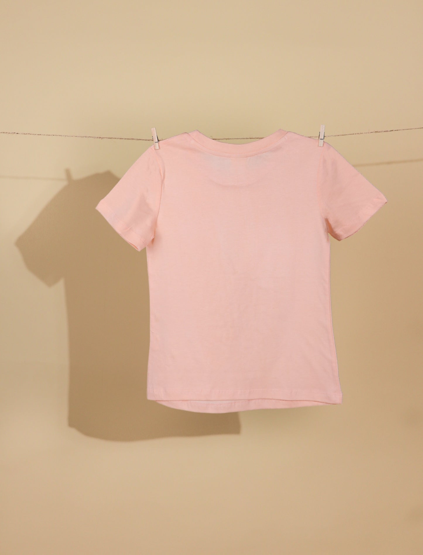 Peach t-shirt on a beige background
