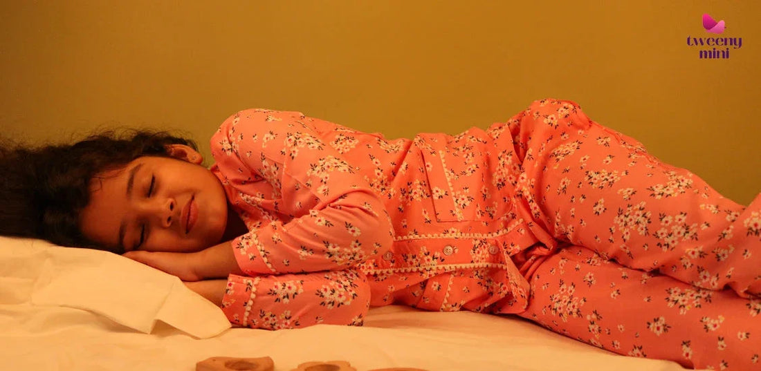 Girl sleeping in a floral pure rayon night suit on a bed, cozy kids sleepwear