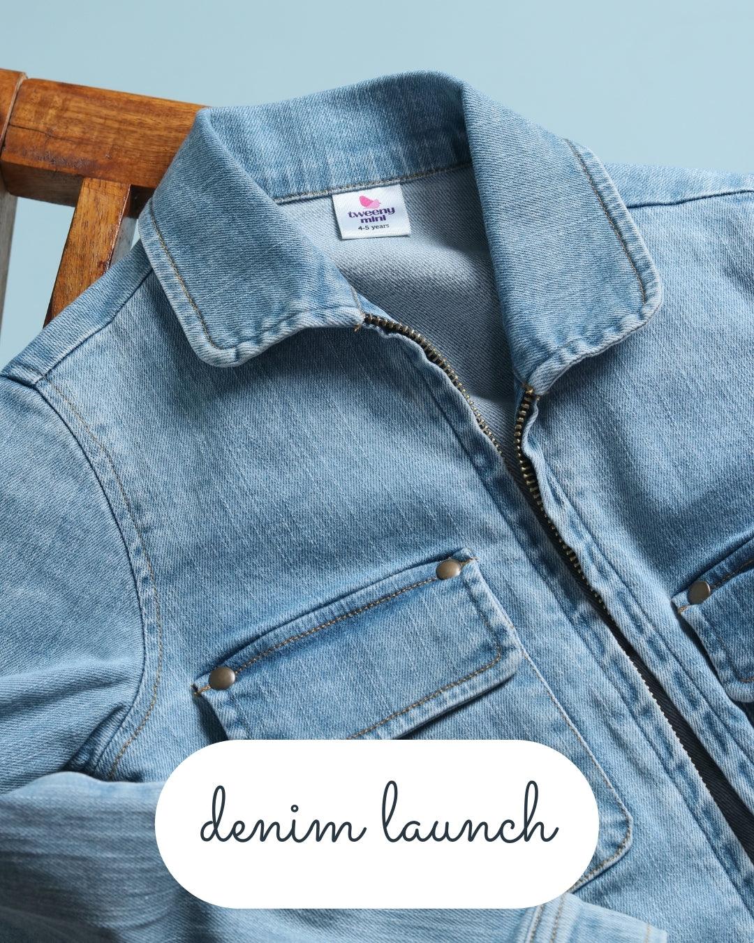 Light blue kids denim jacket with front pockets and zipper on a wooden chair, denim launch