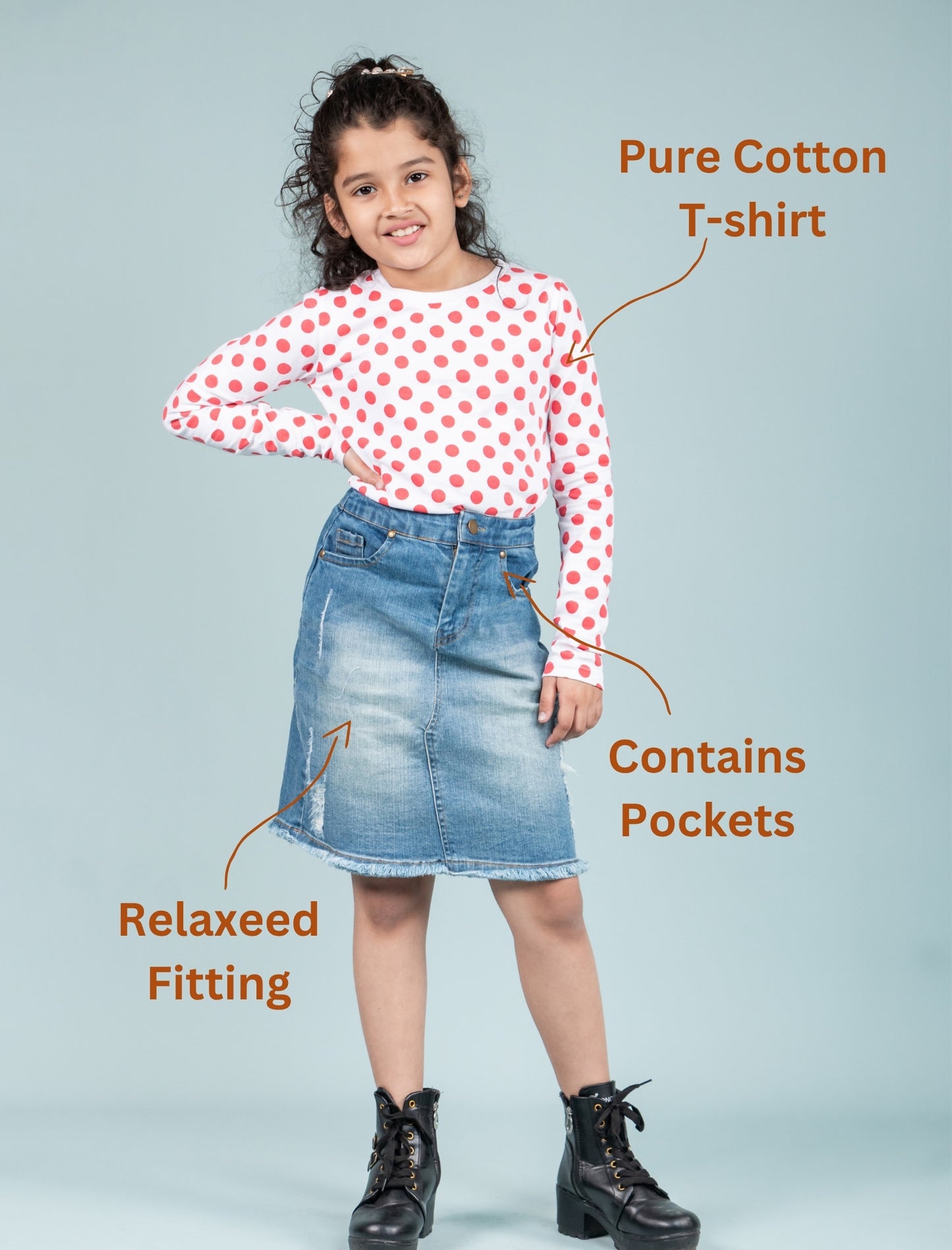 Girl wearing a polka dot t-shirt and denim skirt with text highlighting features on a light blue background