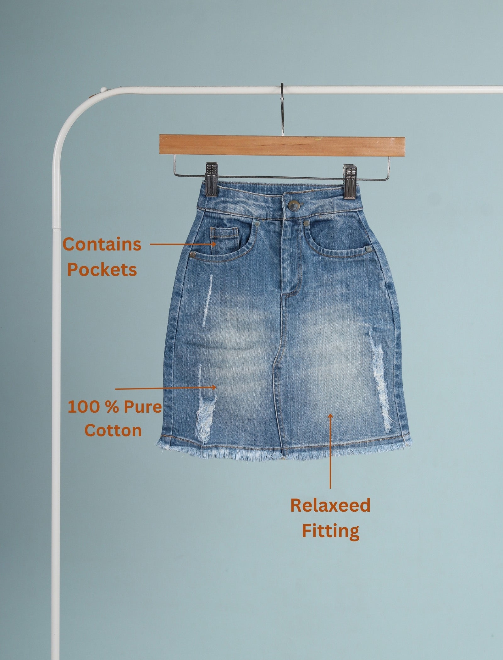 Blue denim skirt on a hanger with text highlighting features against a light blue background