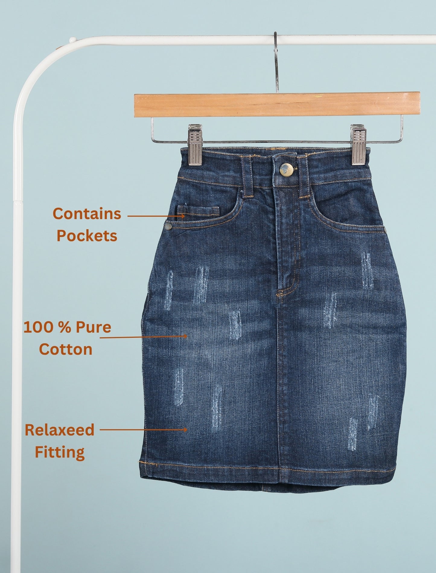 Blue denim skirt on a hanger with text highlighting features on a light blue background