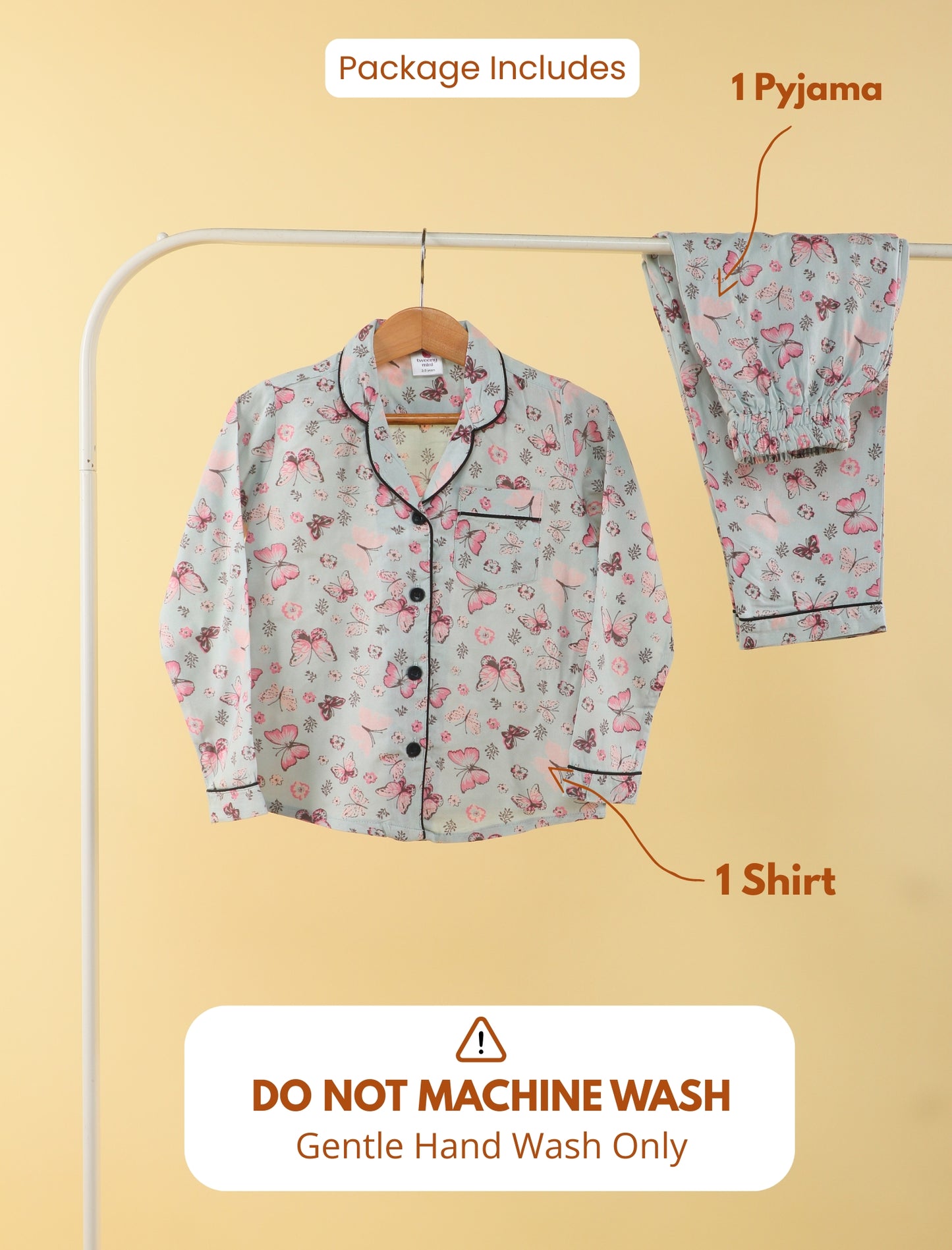 Floral pajama set with shirt and pants on a hanger against a beige background.