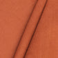 Close-up of rust corduroy fabric with '100% Cotton Corduroy' text.