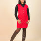 Girls wearing a red dress with a black top and brown boots on a beige background