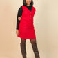 Girls wearing a red dress with a black top and brown knee-high boots on a beige background