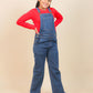 Girls wearing a red shirt and blue denim overalls on a beige background