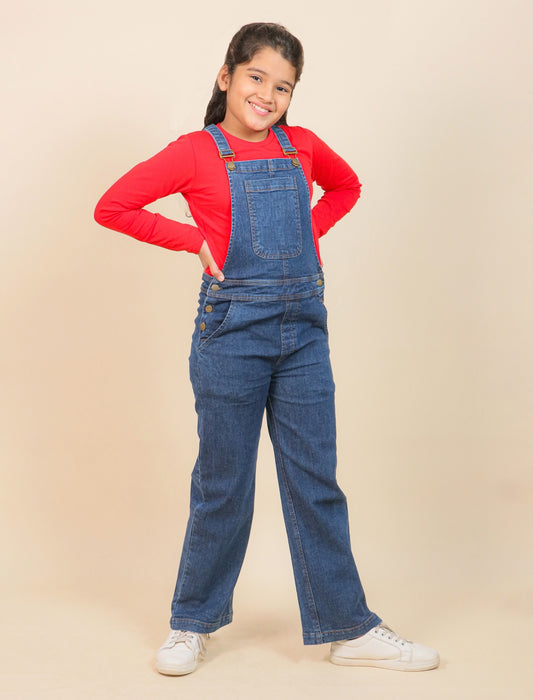 Girls wearing a red shirt and blue denim overalls on a beige background