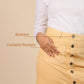 Butterscotch skirt with buttons and pockets on a beige background