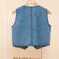 Blue denim vest on a hanger with 'Back view' text on a beige background