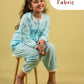 Girl wearing a light blue outfit sitting on a stool with 'Premium Fabric' text above.