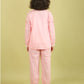 Child wearing a pink outfit on a green background