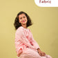 Young girl in a pink outfit sitting on a stool with 'Premium Fabric' text on a yellow background