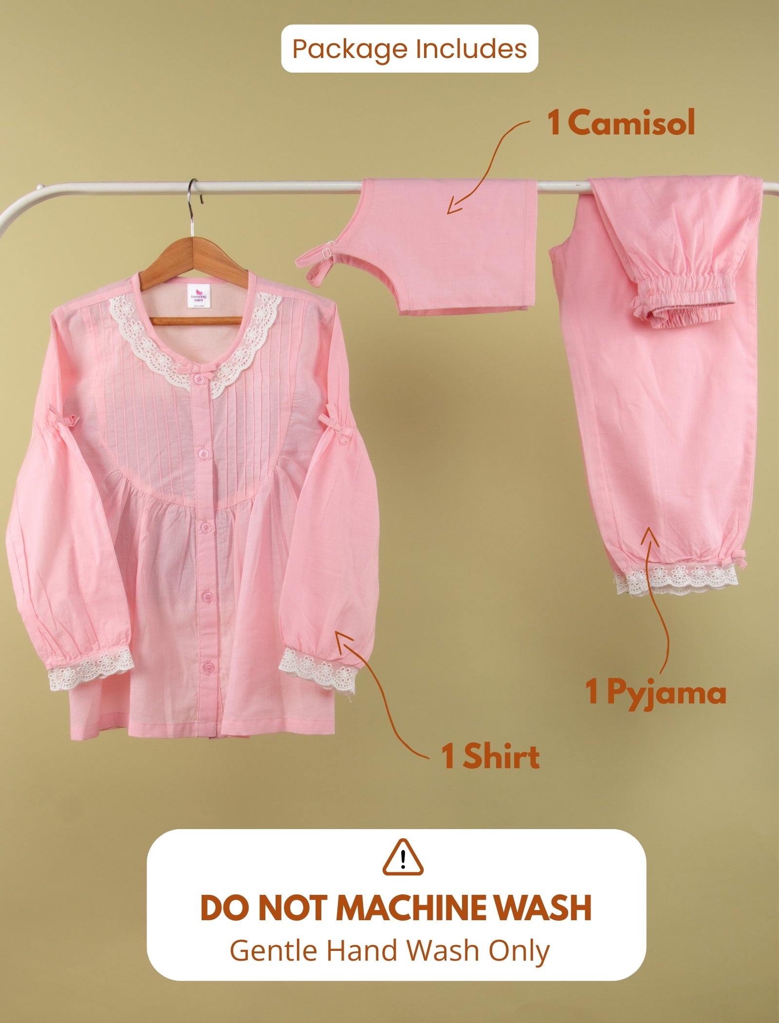 Pink pajama set with shirt, camisol, and pyjama on a hanger against a beige background.