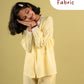 Girls wearing a yellow outfit with 'Premium Fabric' text on a beige background