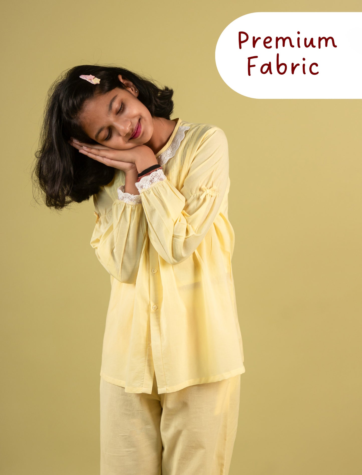 Girls wearing a yellow outfit with 'Premium Fabric' text on a beige background