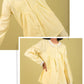 Yellow outfit with white lace details on a yellow background