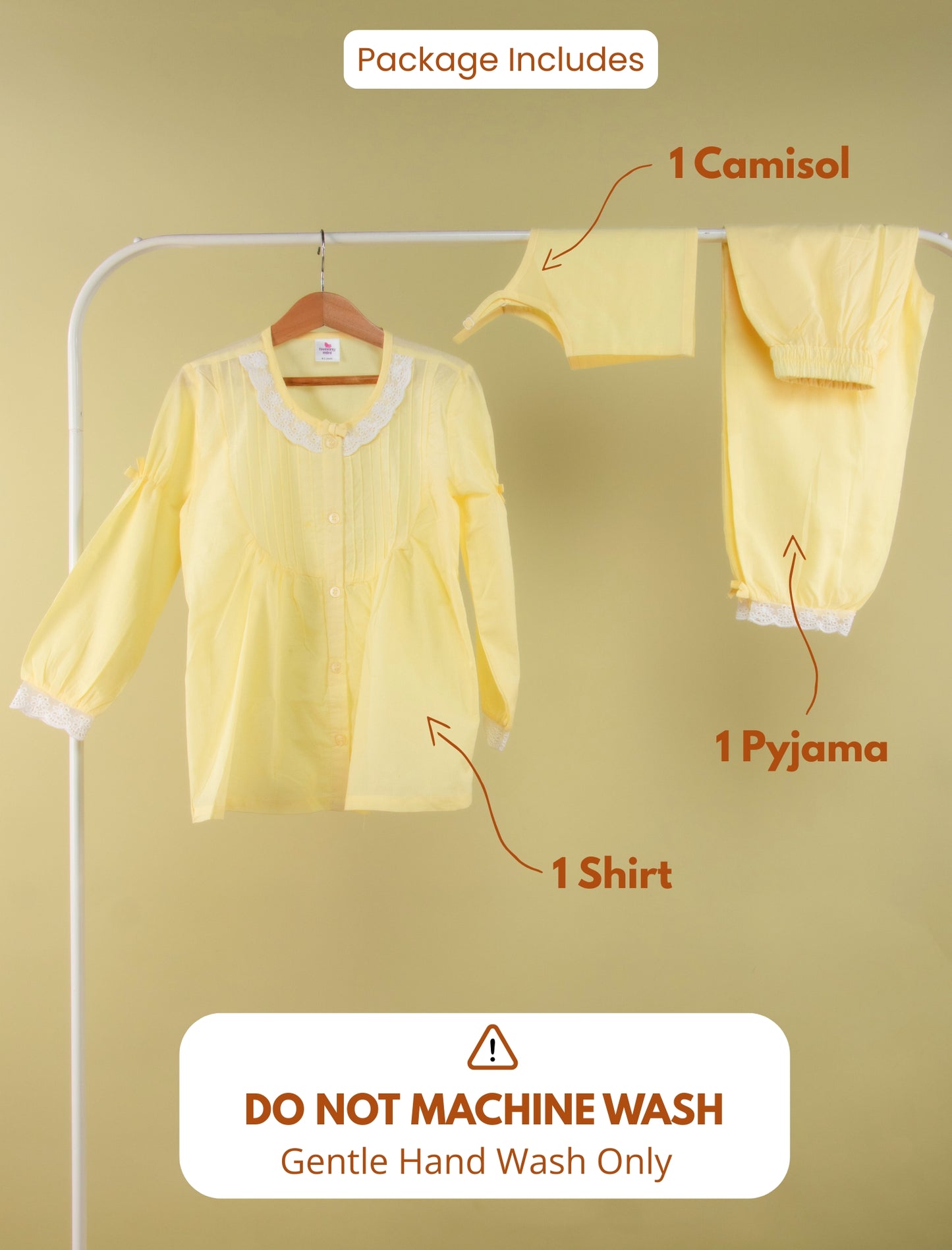 Yellow outfit with camisol, shirt, and pyjama on a hanger against a beige background.