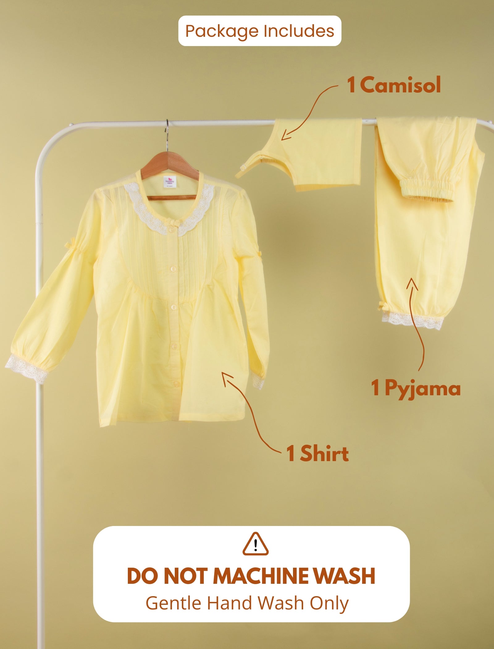 Yellow outfit with camisol, shirt, and pyjama on a hanger against a beige background.