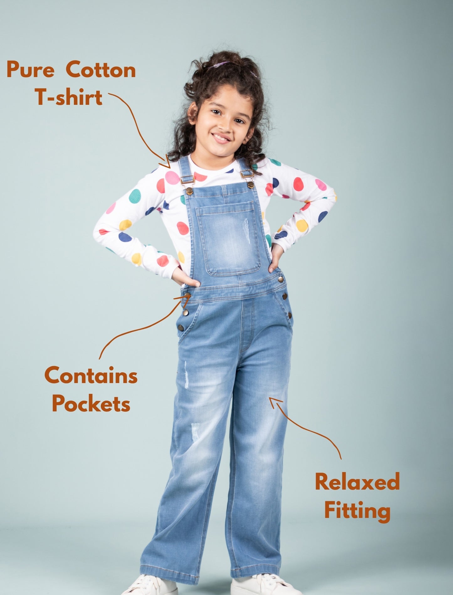 girl wearing a colorful t-shirt and blue denim overalls with text highlighting features.
