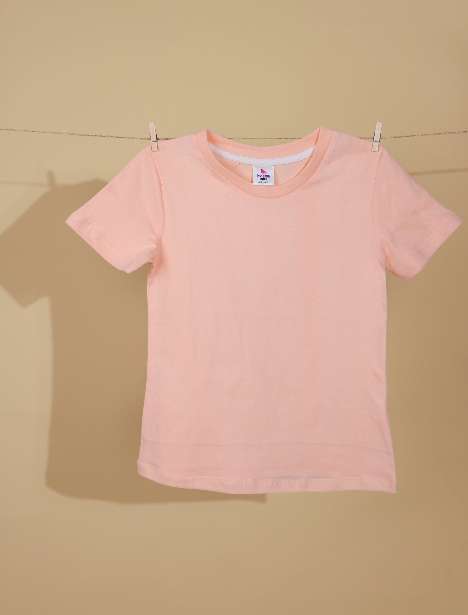 Peach t-shirt on a beige background