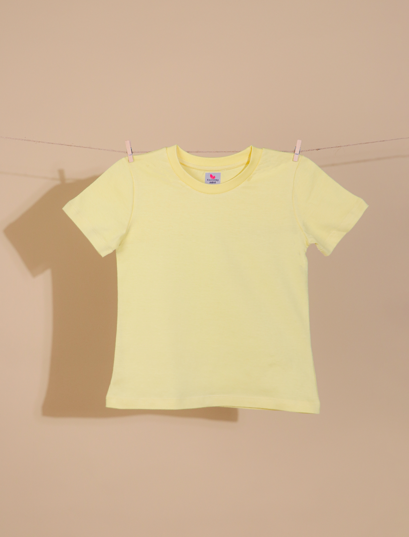 Yellow t-shirt on a beige background