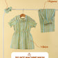 Set of clothes including a dress, shirt, and pyjama on a rack with text indicating package contents and washing instructions.
