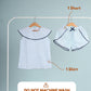 Girls shirt and shorts on hangers with washing instructions on a gray background