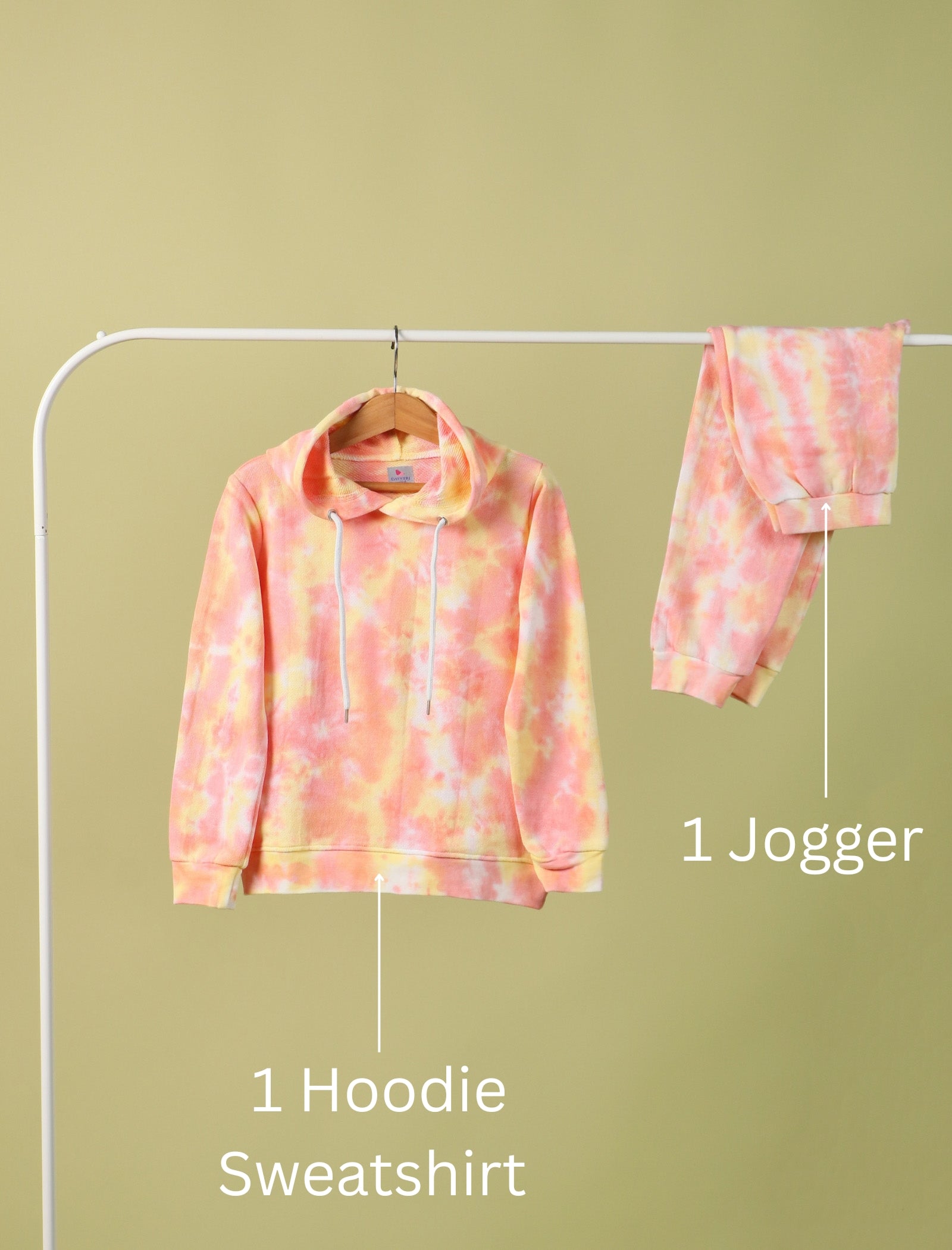 Tie-dye hoodie and jogger set on a rack against a green background
