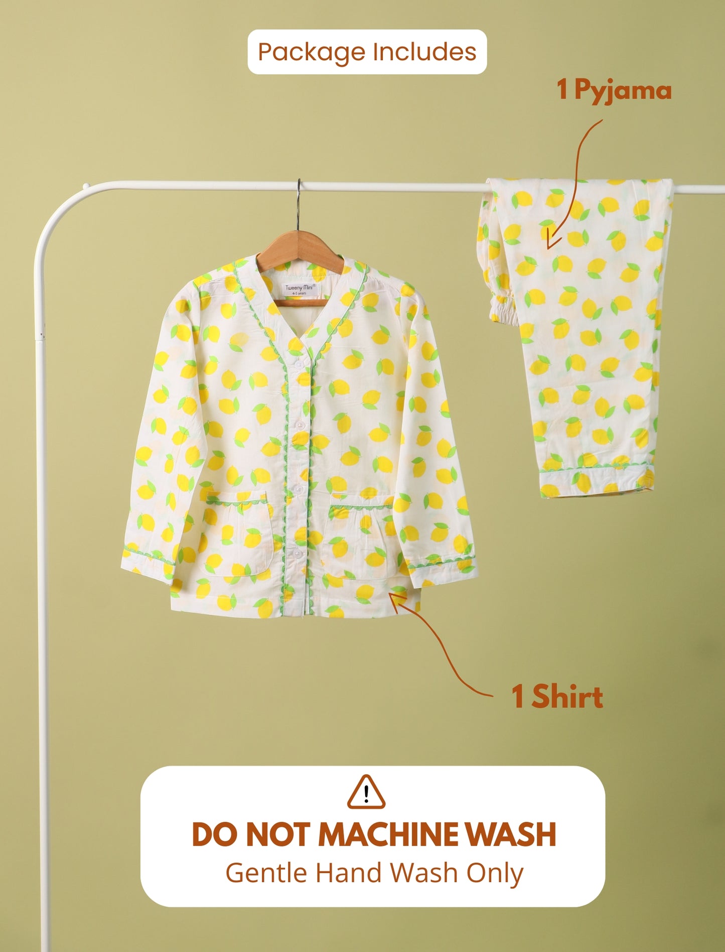 Girl's pajama set with shirt and pants on a hanger against a beige background.