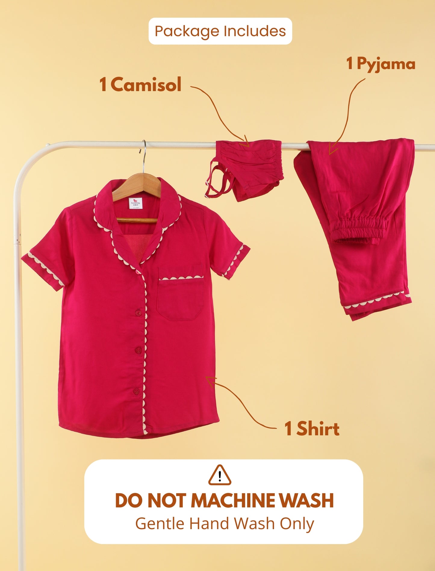 Red girls clothing set with shirt, camisole, and pyjama on a hanger against a beige background.