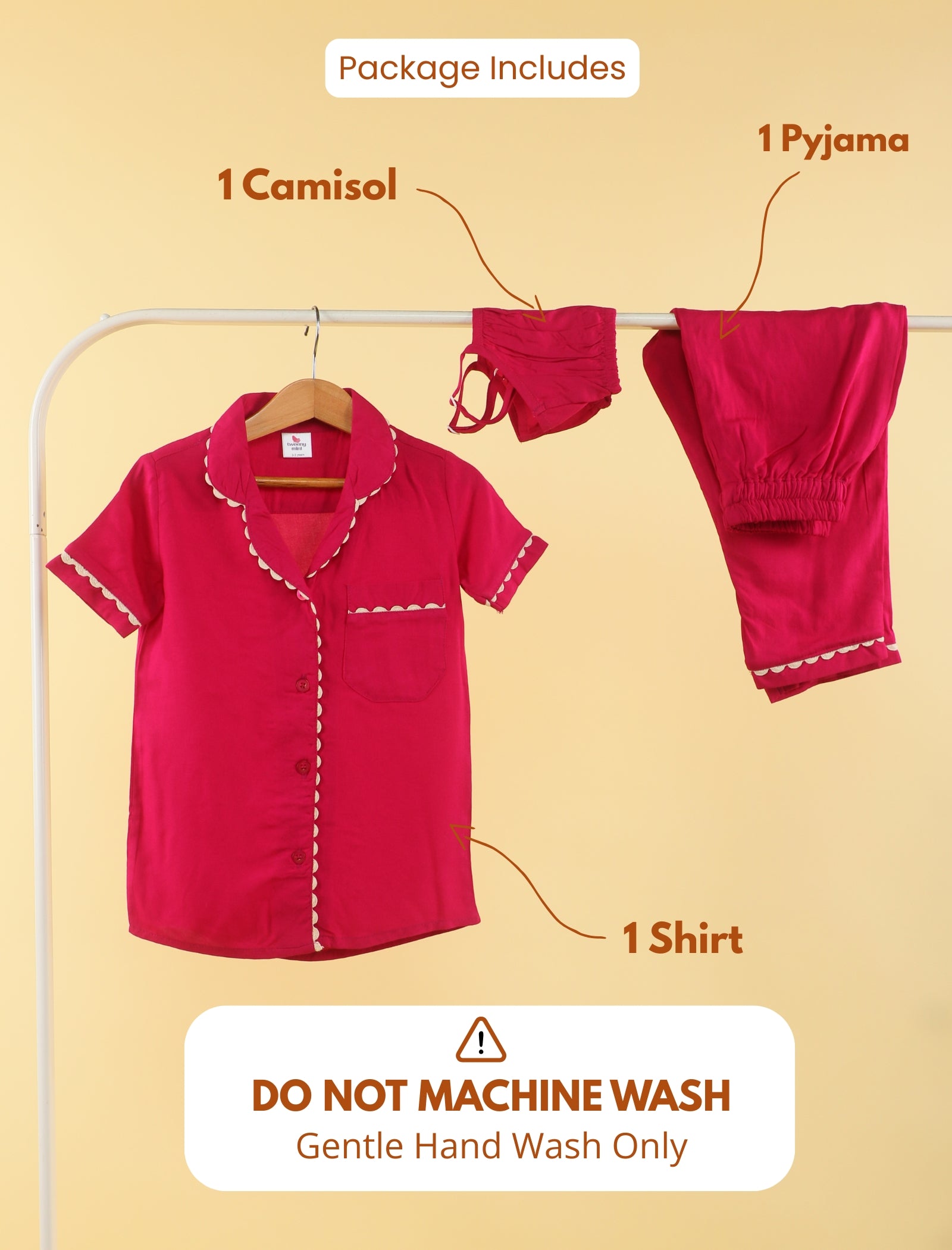 Red girls clothing set with shirt, camisole, and pyjama on a hanger against a beige background.
