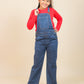Girls wearing a red shirt and blue denim overalls on a beige background