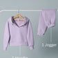 Purple hoodie sweatshirt and jogger pants on a gray background with labels.