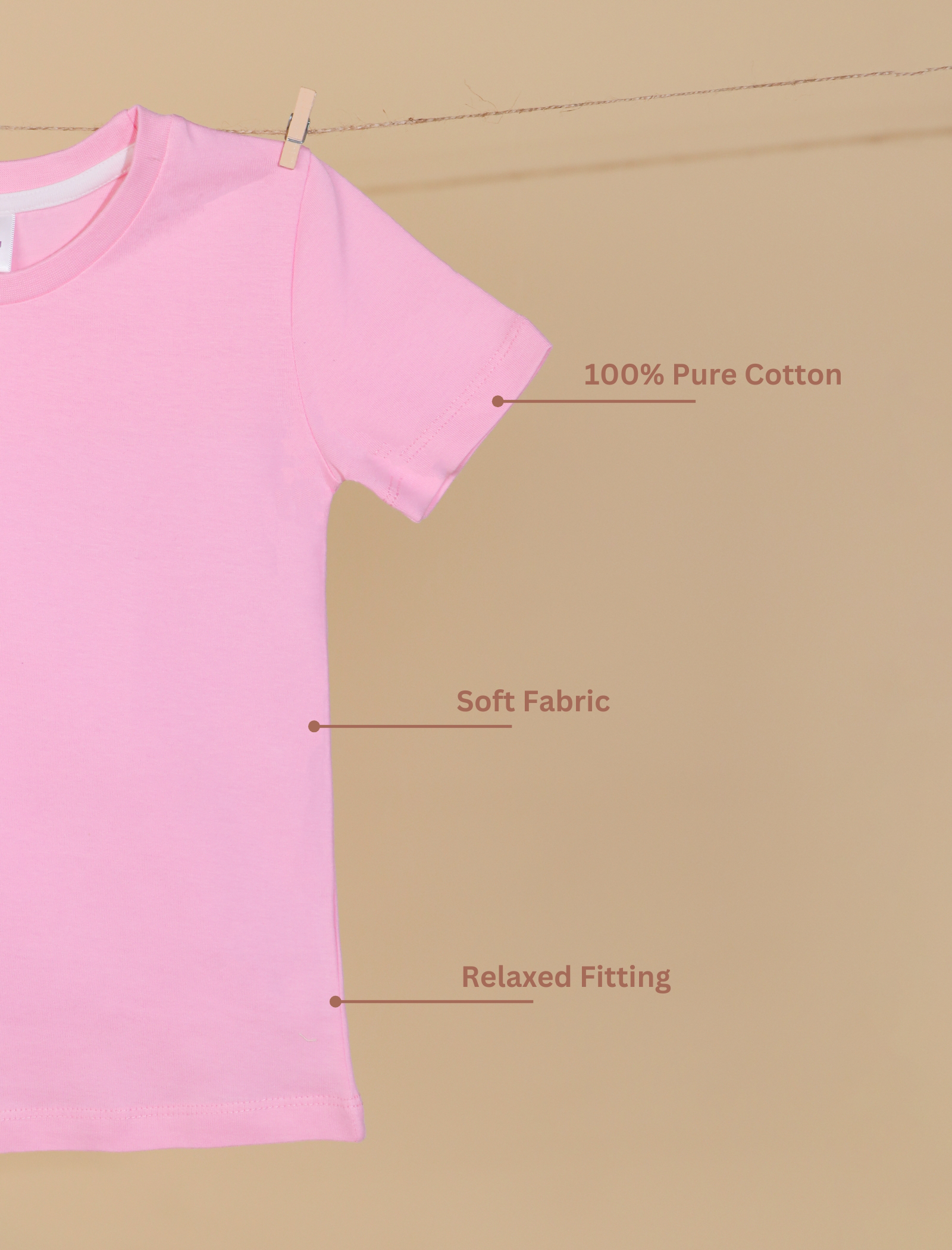 Pink t-shirt on a beige background with text indicating features like 100% pure cotton, soft fabric, and relaxed fitting.