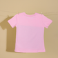 Pink t-shirt on a clothesline against a beige background