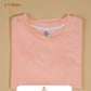 Peach t-shirt with a label on a beige background