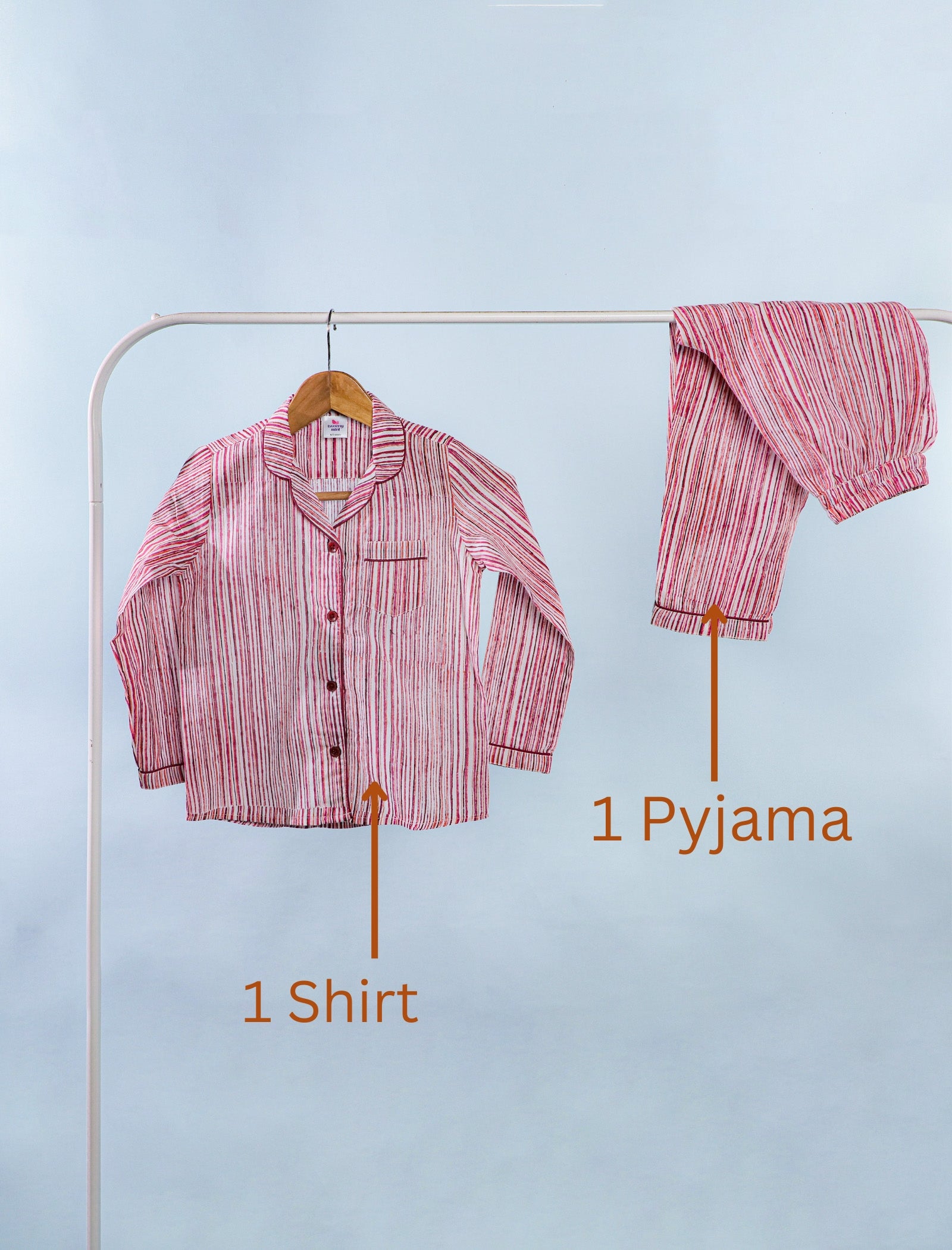 Pink striped shirt and pyjama set on a rack with labels indicating the items.