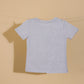 Gray t-shirt on a clothesline against a beige background