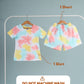 Set of colorful shirt and shorts on hangers with washing instructions on a gray background