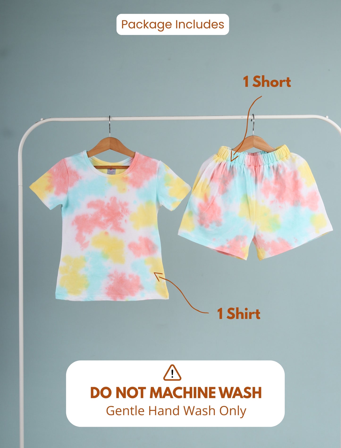 Set of colorful shirt and shorts on hangers with washing instructions on a gray background