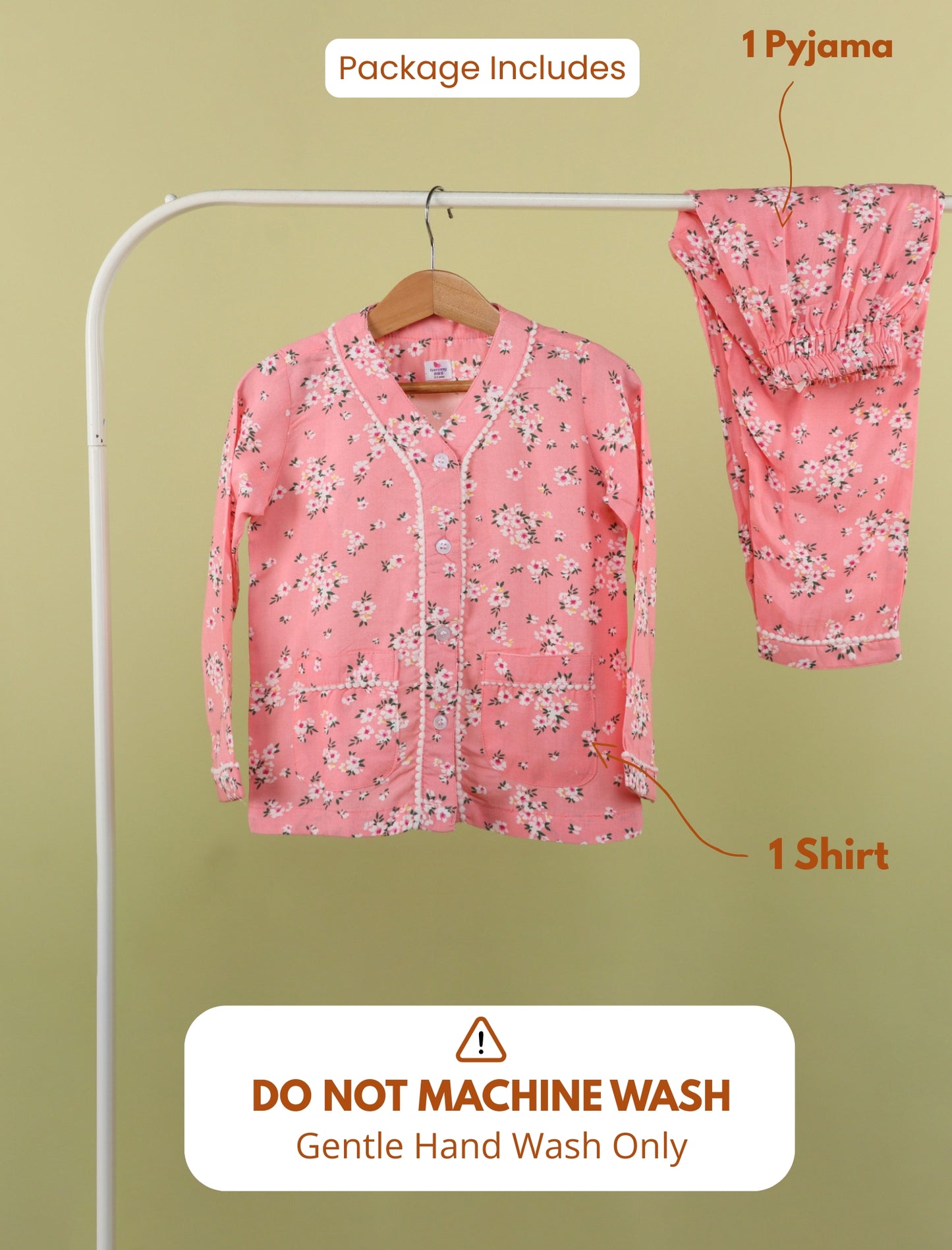 Pink floral pajama set with shirt on a hanger against a green background, with washing instructions displayed.