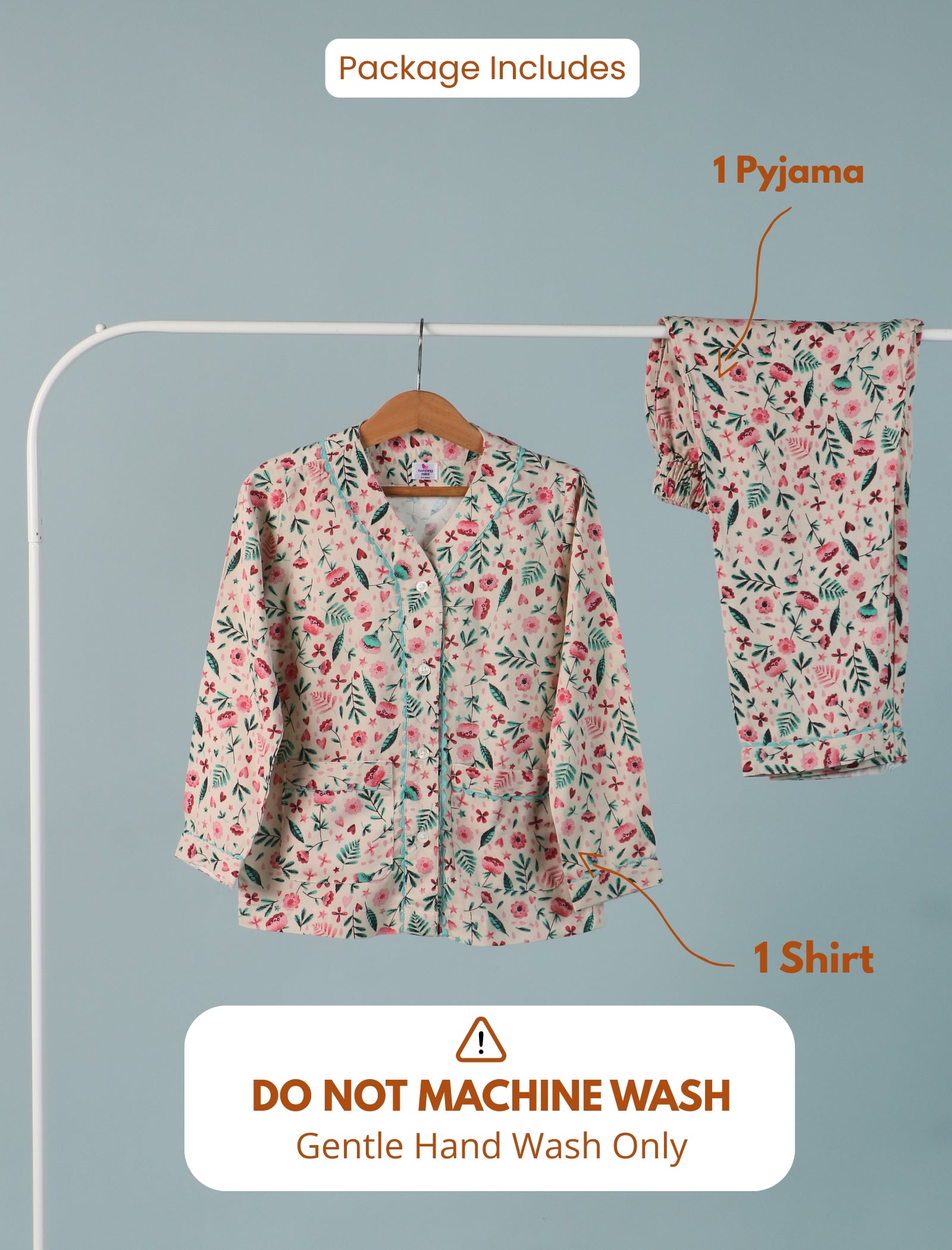 Floral pajama set with shirt and pants on a hanger against a gray background, with text indicating care instructions.