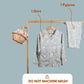Set of shirt and pyjama on a wooden rack with text indicating contents and washing instructions.