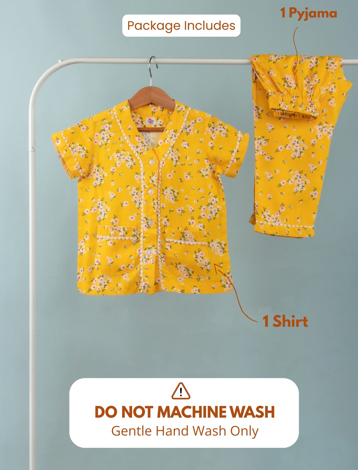 Yellow floral shirt and pajama set on a hanger with washing instructions.