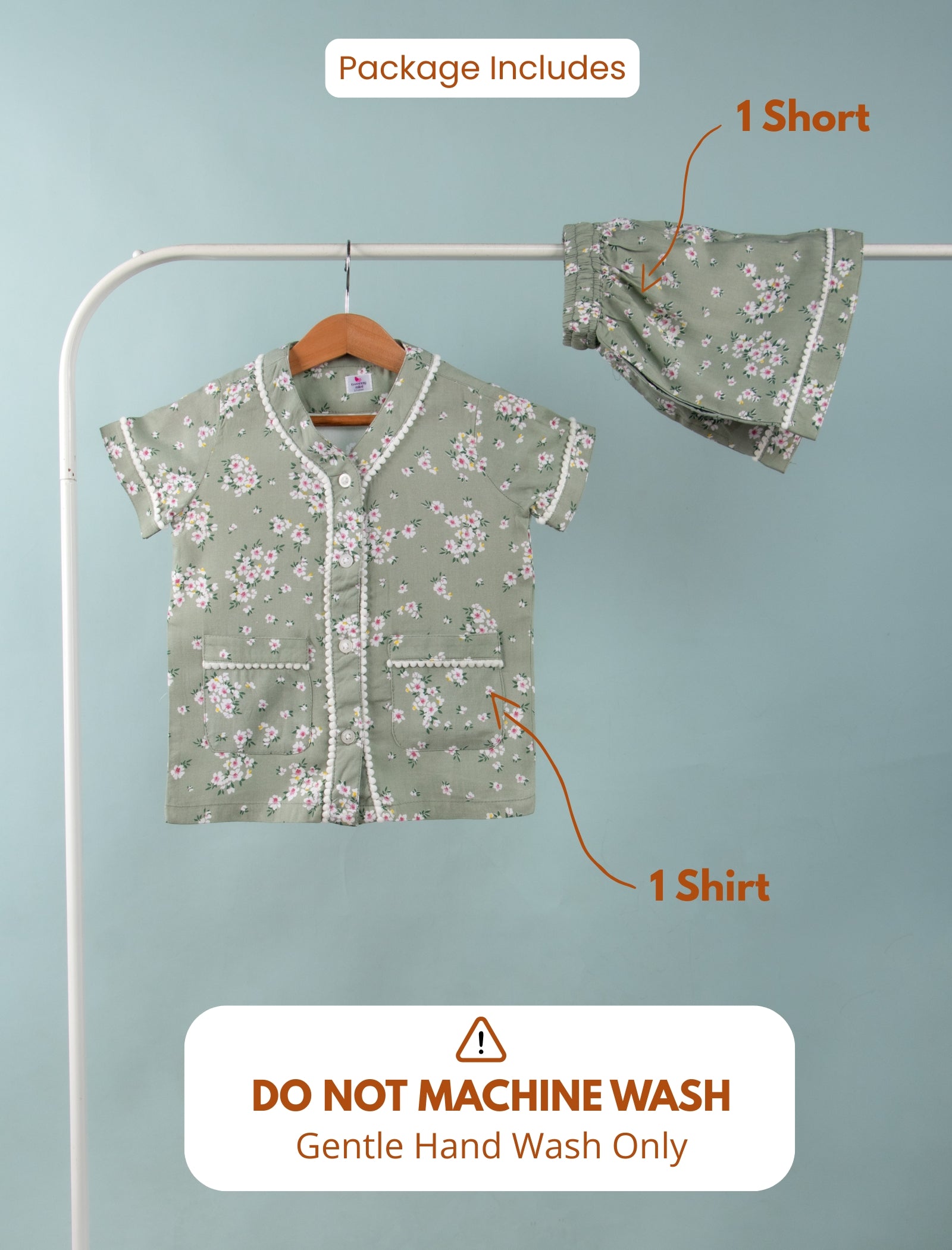 Girls outfit with shirt and shorts on a rack against a light blue background.