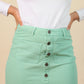 Light green skirt with buttons on a beige background