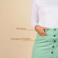 Green skirt with button details and pockets on a beige background