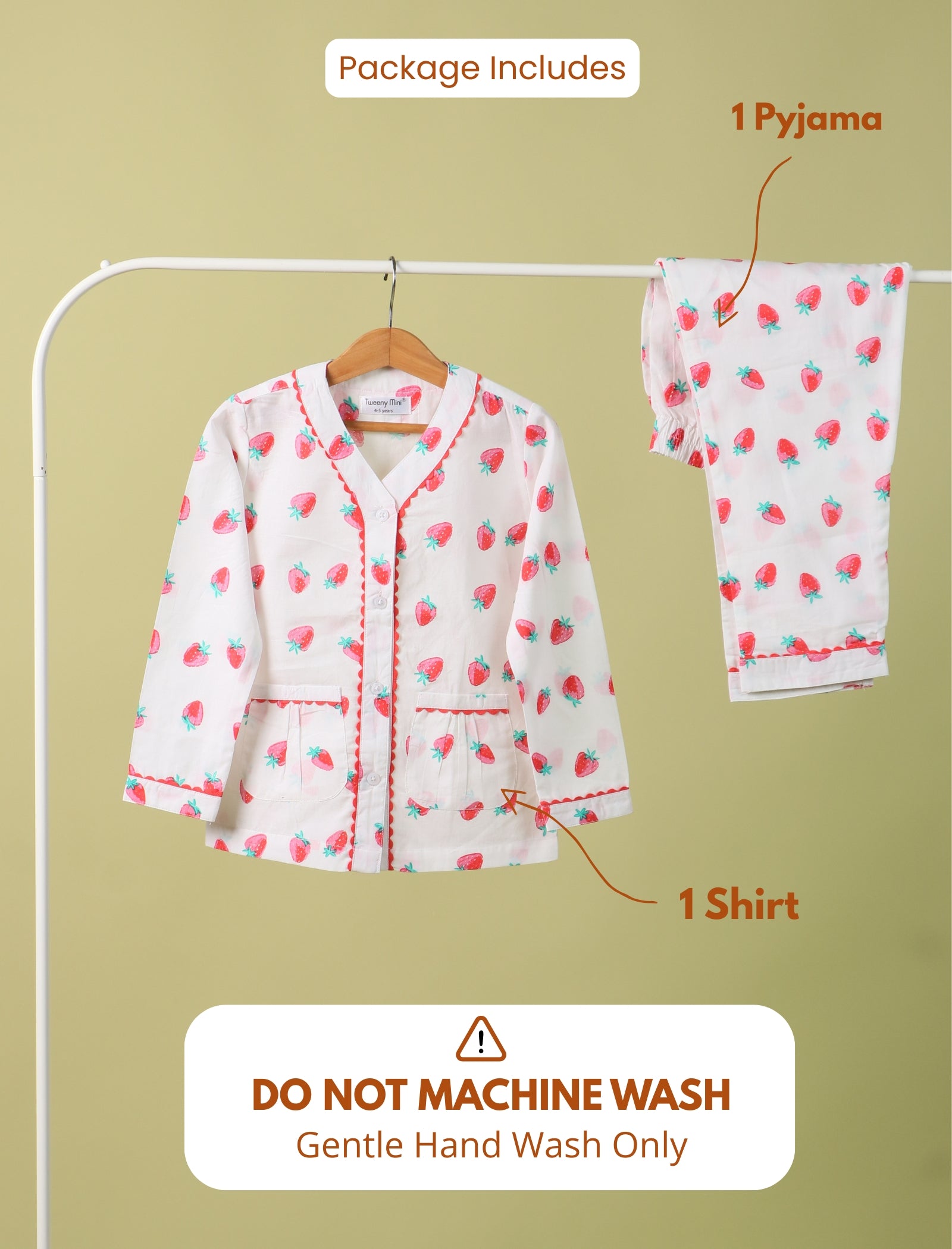 Girls kids pyjama set with shirt and pants on a hanger against a beige background.